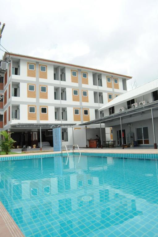 a large swimming pool in front of a building at Nanya Hotel Chiang Mai in Chiang Mai