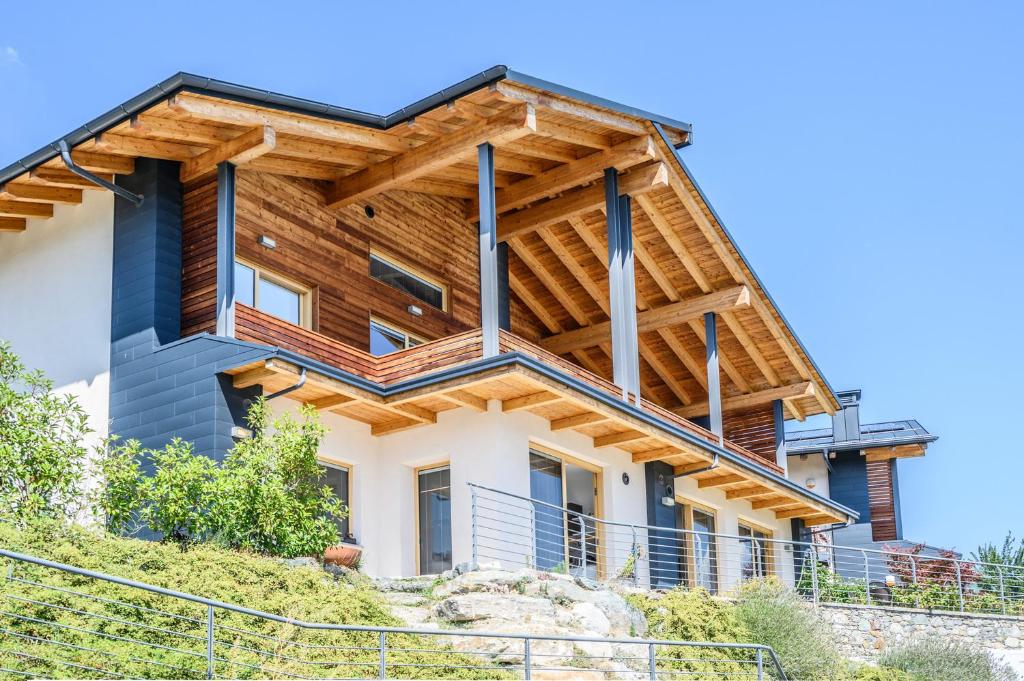 a house with a wooden roof at Alpine Aura Loft- Privacy, Relax, Mountain View in Saint-Christophe
