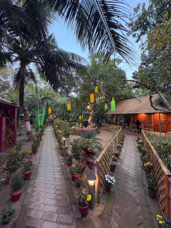 a garden with potted plants and lights on a street at WildDunes Eco Resort Konark in Bālighāi