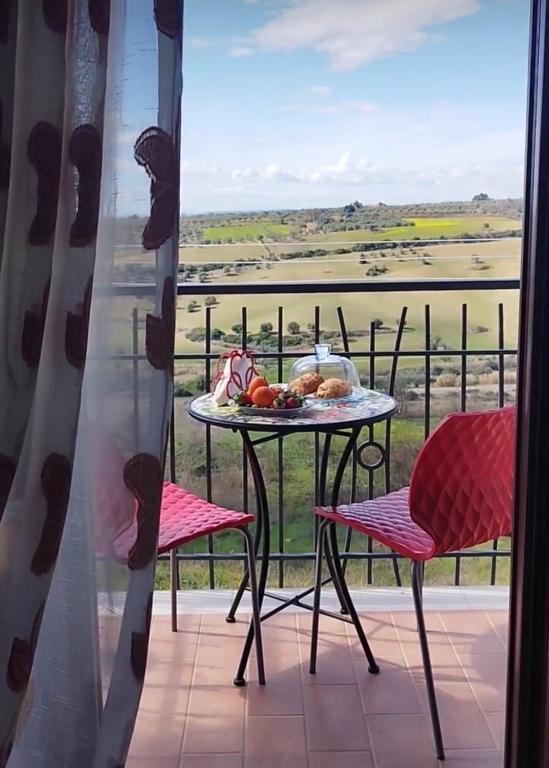 a table and chairs on a balcony with a view at Massanè Casa Vacanza in Ginosa