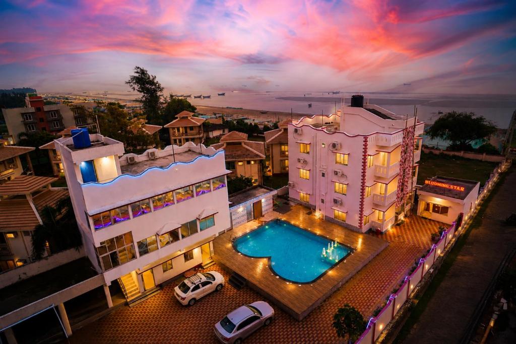 an aerial view of a building with a swimming pool at Blooming Star in Mandarmoni