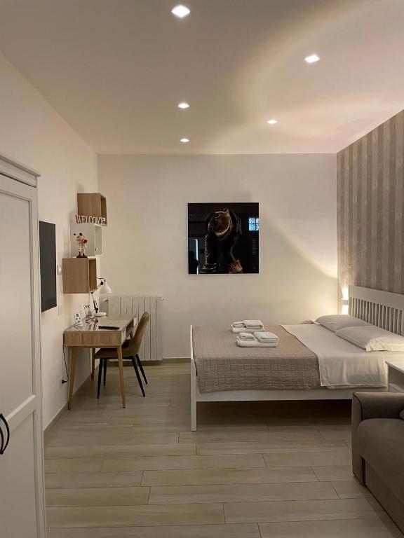 a bedroom with a bed and a television on the wall at Home-Carrara in Naples