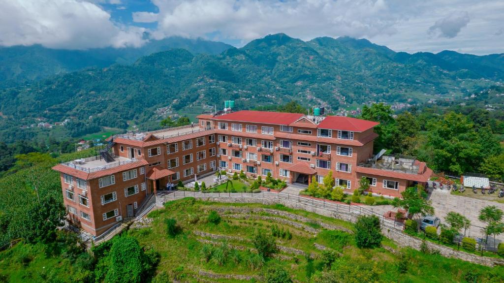 a building on a hill with mountains in the background at Landmark Diamond Hill in Panaoti