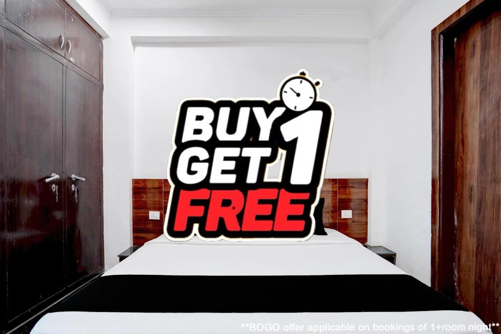 a bedroom with a buy get free sign on a bed at Hotel O India Expo Mart Noida Formerly Xponest in Greater Noida
