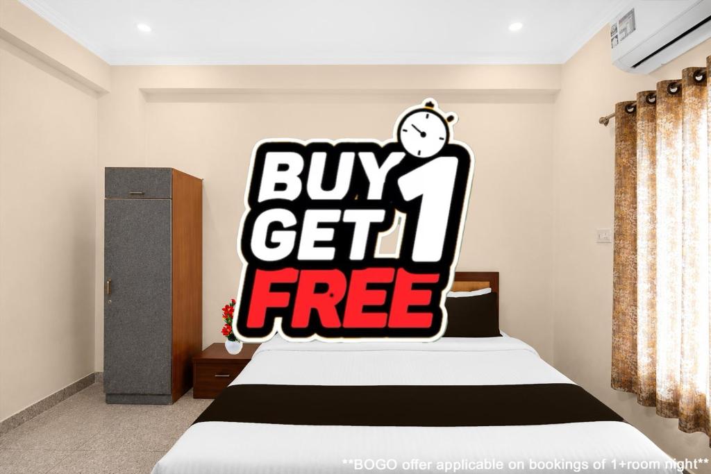 a bedroom with a buy get free sign on a bed at Collection O Salasar Balaji Temple Formerly Hanuwant Palace in Sīkar