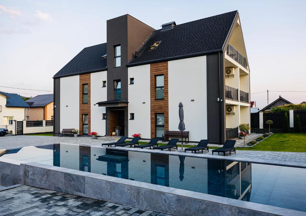a house with a swimming pool in front of it at Апартаменти Velvet Rooms in Skhidnitsa
