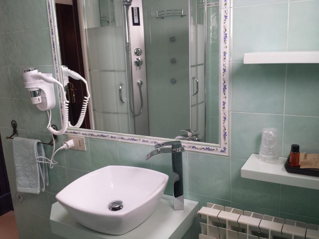 a bathroom with a sink and a mirror at Villa Kuky in Santa Teresa Gallura
