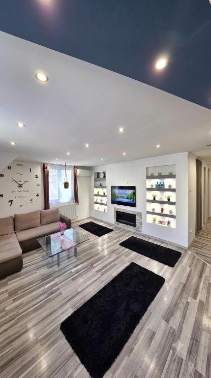 a large living room with a couch and a table at Stay4U Veszprém in Veszprém
