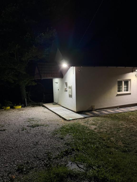a house with a light on the side of it at night at ALBAK Green Zone in Gradačac