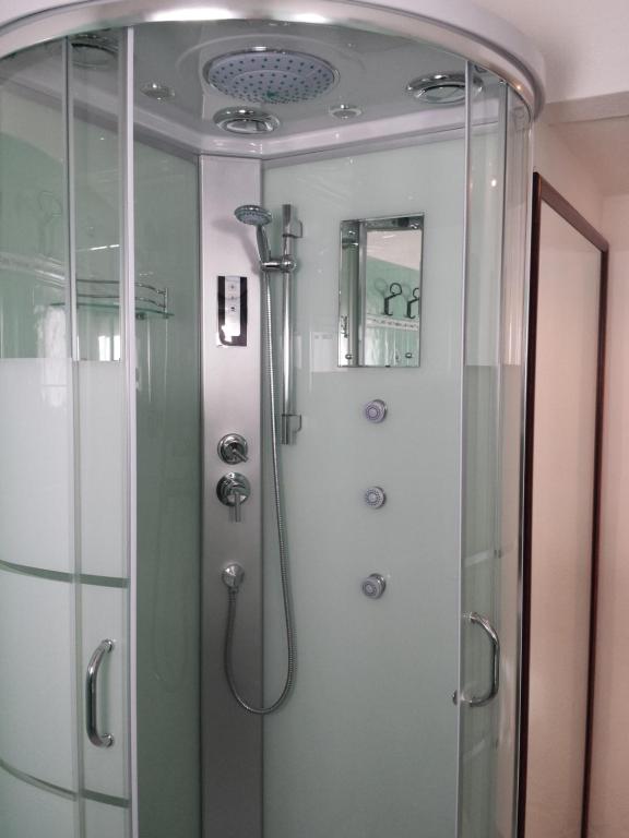 a shower in a bathroom with a glass shower stall at Villa Kuky in Santa Teresa Gallura