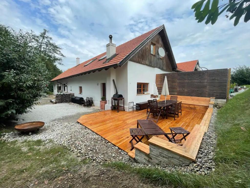 a house with a wooden deck in front of it at Chalet Notschkerl in Waasen
