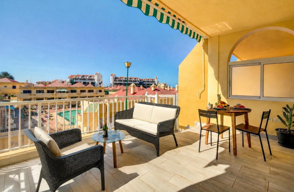 a patio with chairs and a table on a balcony at Cosy Mareverde FREE WIFI by Olax Rentals in Adeje