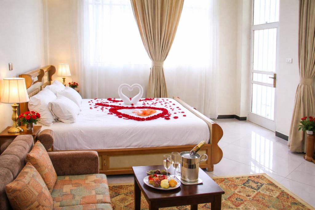 a hotel room with a bed with a heart on it at Avi Guest House in Addis Ababa