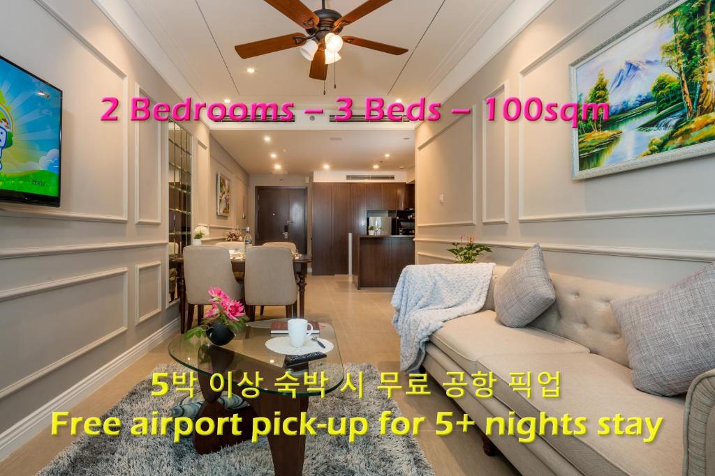 a living room with a couch and a table at Beachfront Luxury Apartment - Rooftop pool - Da Nang in Danang