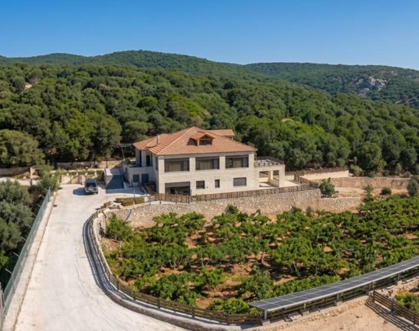 a house on a hill with a road at Bait Ajloun in Khirbat Shīn