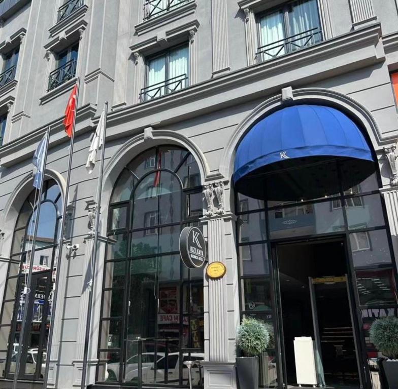 a store front of a building with a blue awning at Kızılkaya Business Otel in Korfez