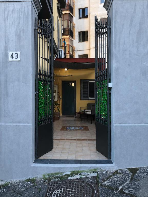 an entrance to a house with a black gate at Alla Chiesetta in Naples