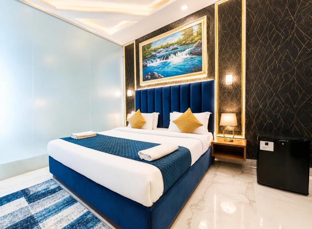a bedroom with a blue and white bed in a room at Hotel Ve Atlantiis Elite in New Delhi