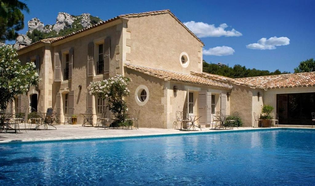 a house with a swimming pool in front of it at Benvengudo in Les Baux-de-Provence