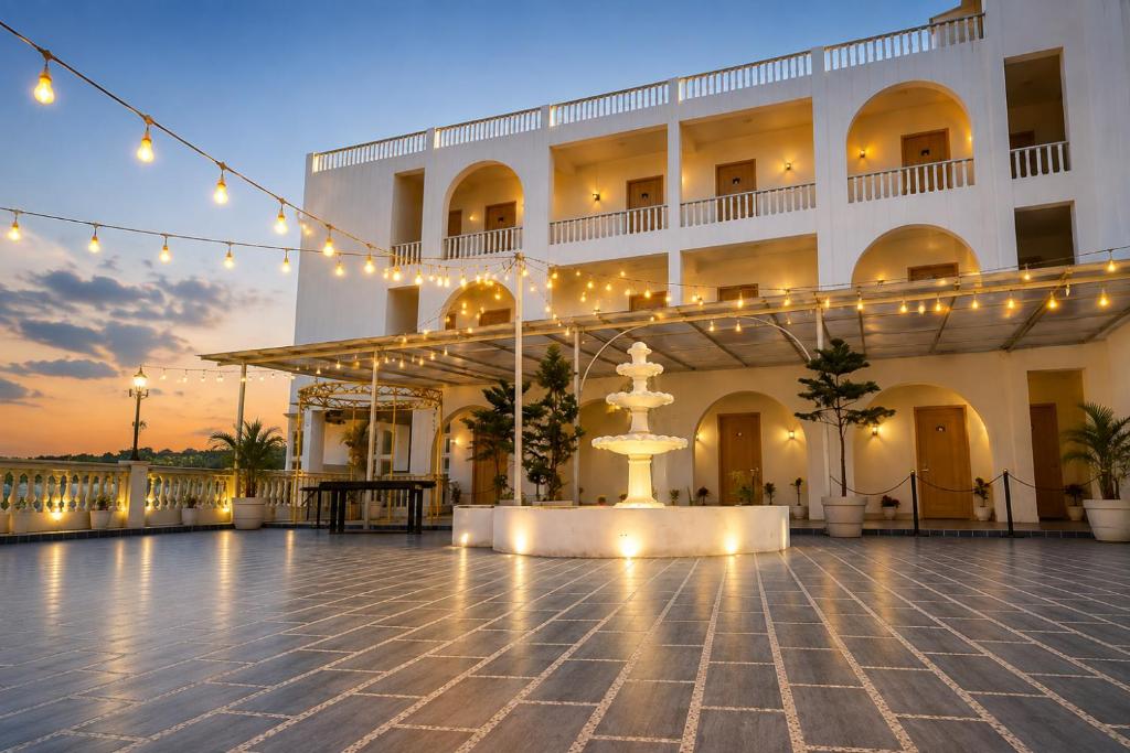 a large building with a fountain in front of it at Ravira Resort in Sītāpur