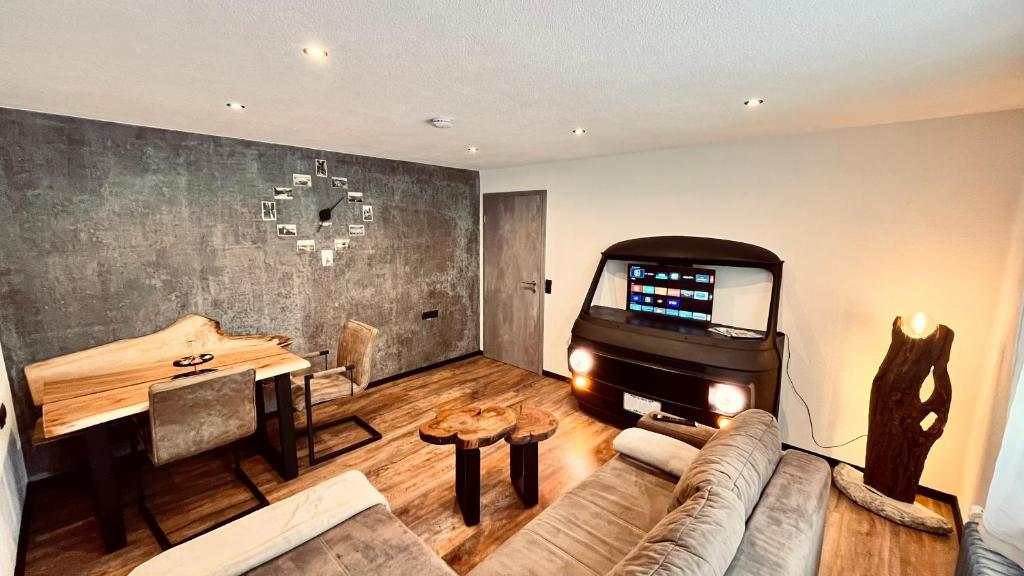 a living room with a couch and a flat screen tv at unique Ferienwohnung in Leutkirch im Allgäu