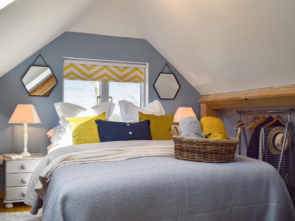 a bedroom with a bed with yellow and blue pillows at Shepherd's Loft in Benson