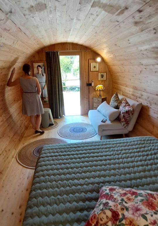 a woman standing in a living room in a house at Botte dei Benandanti in Vivaro
