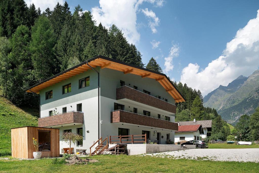 a house with a gambrel roof on top of it at Nature House Pflersch in Brennero