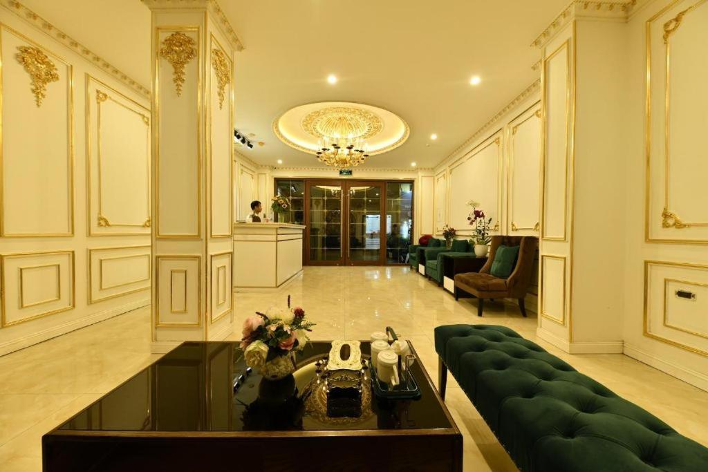 a large living room with a couch and a table at Kingdom Hanoi Hotel in Hanoi