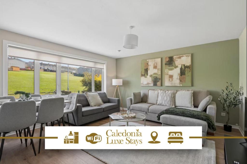 a living room with a couch and a table at Lime Grove House in Dalkeith
