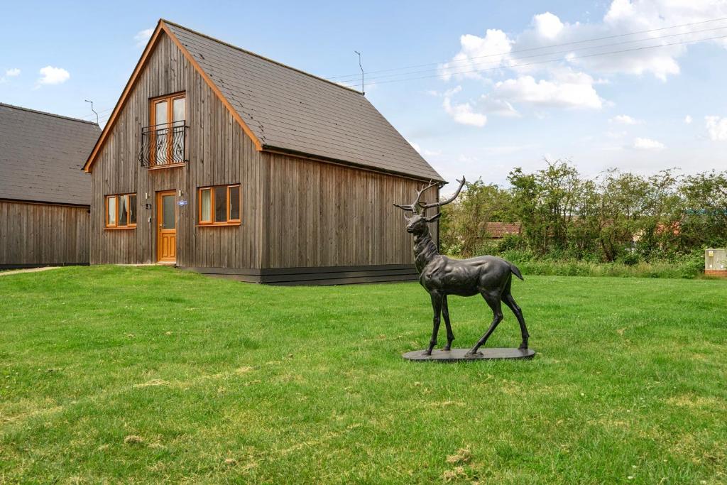 a statue of a deer in front of a house at Pumpkin Lodge in Brigg