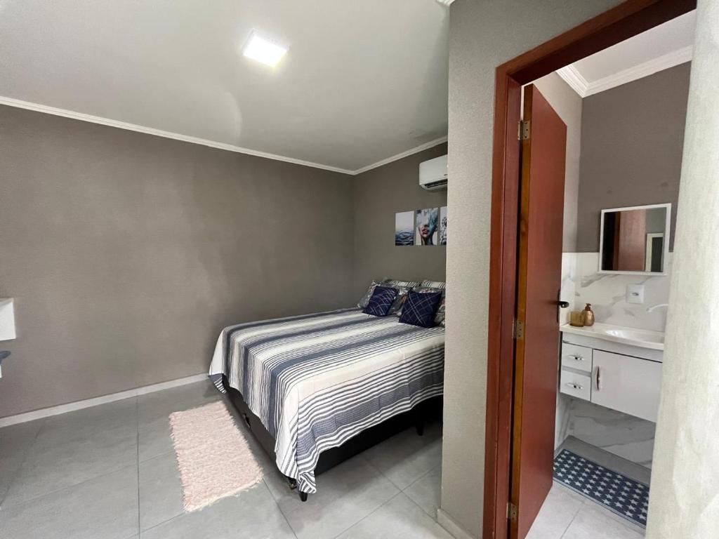 a bedroom with a bed and a sink at Pousada Recanto Sossego in Saquarema
