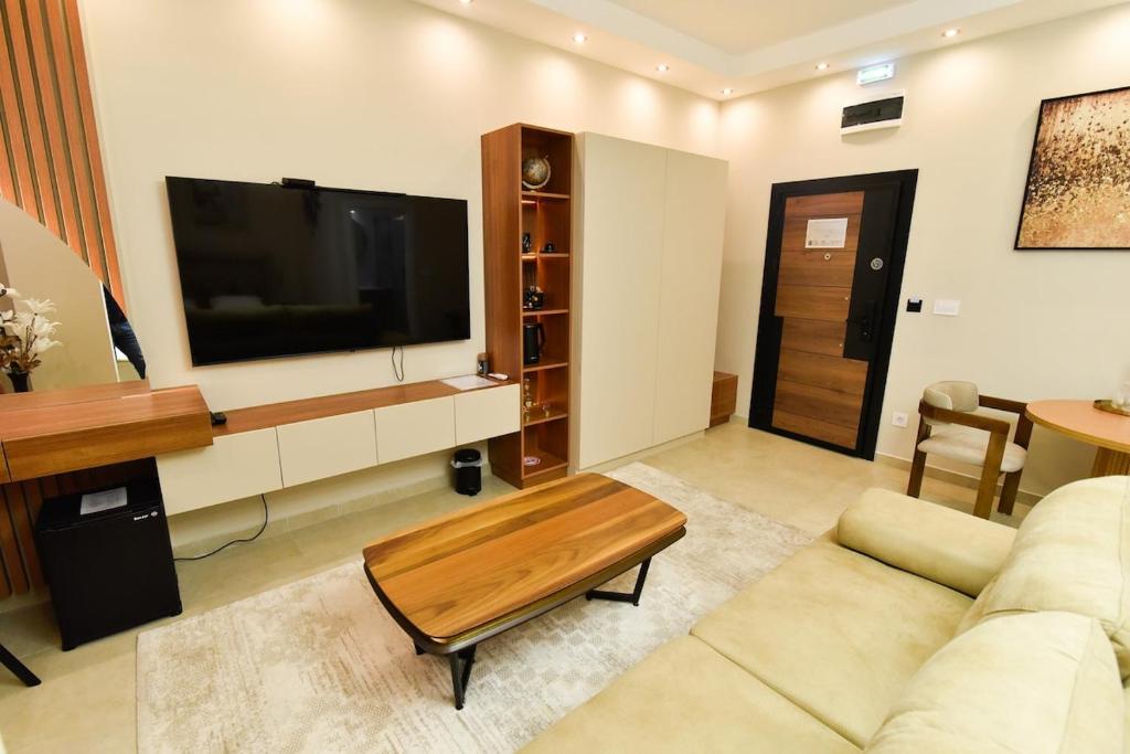 a living room with a couch and a flat screen tv at Dream Palace 1 in Belgrade