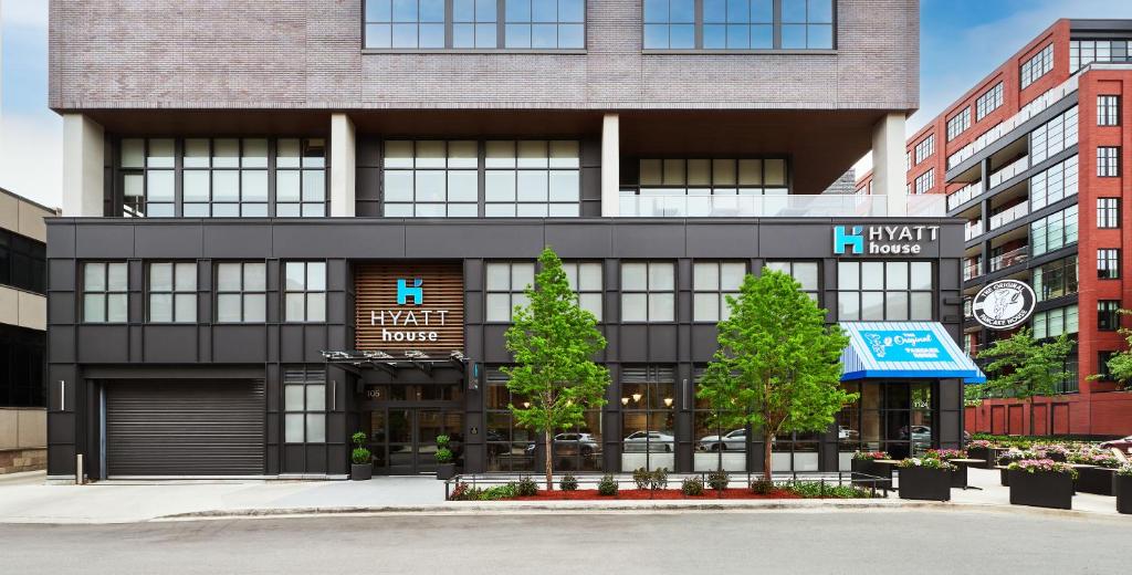a black building with trees in front of it at Hyatt House Chicago West Loop-Fulton Market in Chicago