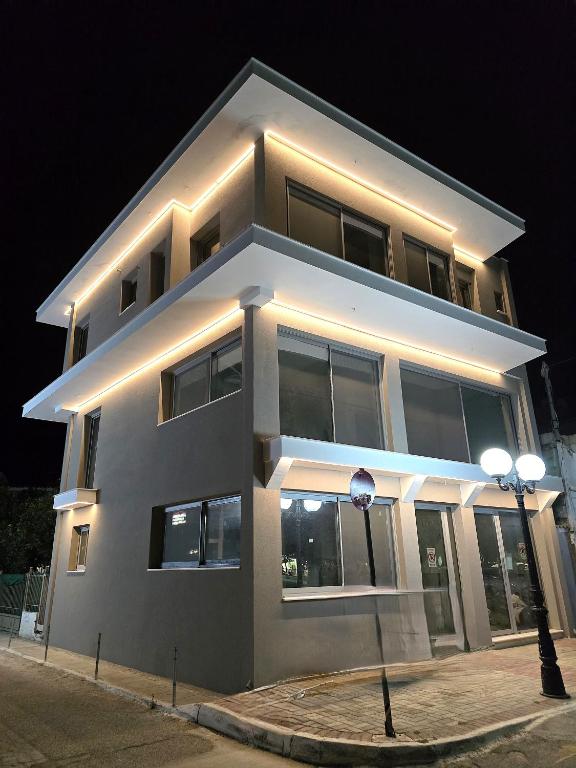 a large building with lights on it at night at Evia Plaza Suites in Amarynthos