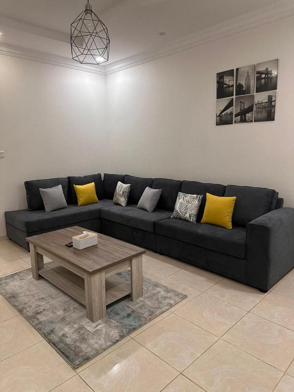 a living room with a couch and a coffee table at شقة لك بالكامل in Taif