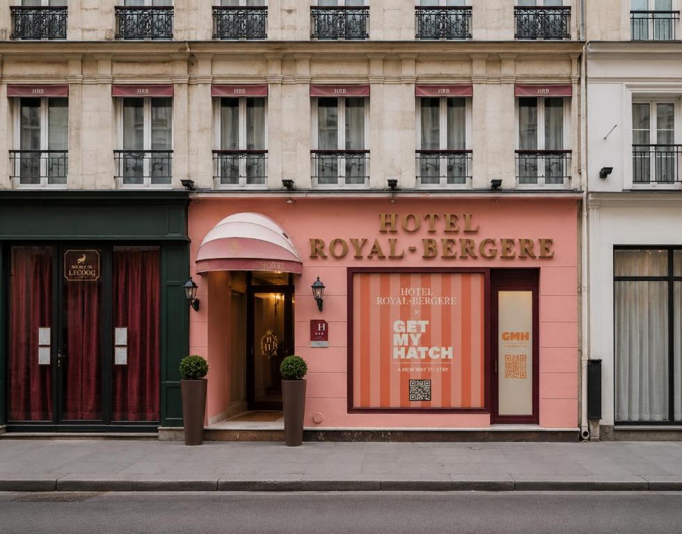 a facade of a building with a hotel royal breeze at Get My Hatch Bergère in Paris
