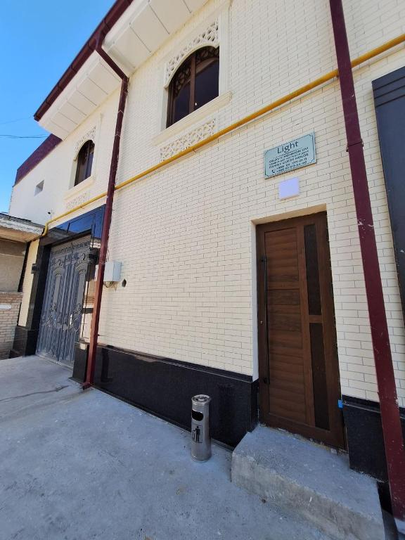 a building with a door on the side of it at Light guest house in Samarkand