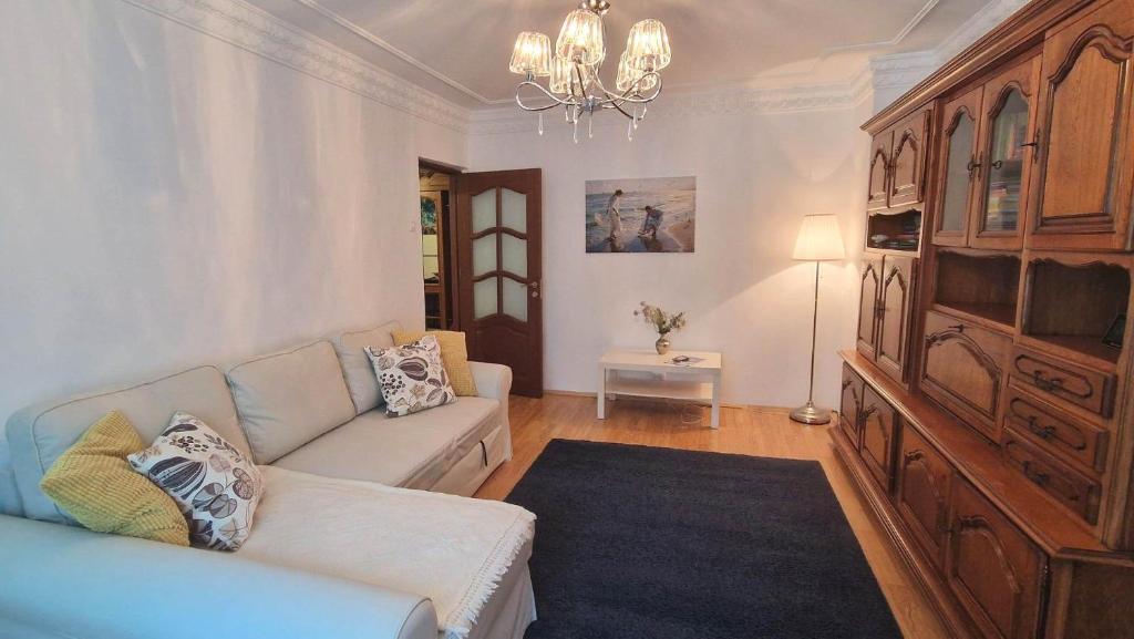 a living room with a couch and a chandelier at Apartament ALBATROS in Mangalia