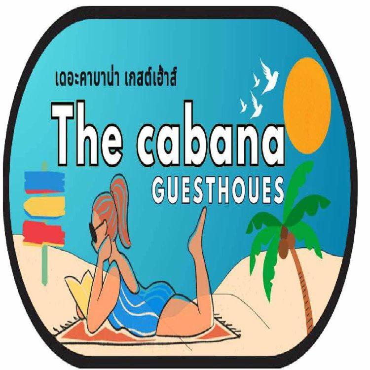 a woman laying on a beach with a book at The cabana guesthouse in Cha Am