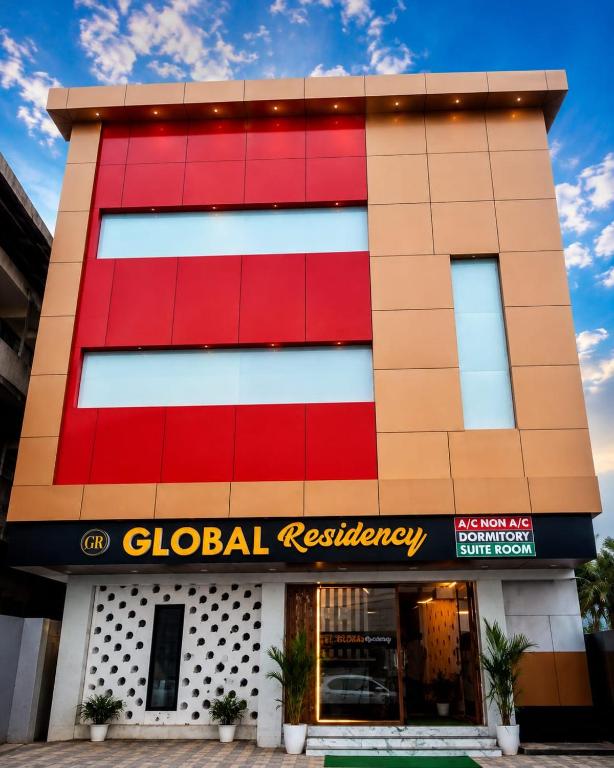 a building with a red colonial residency at Global Residency in Palakkad