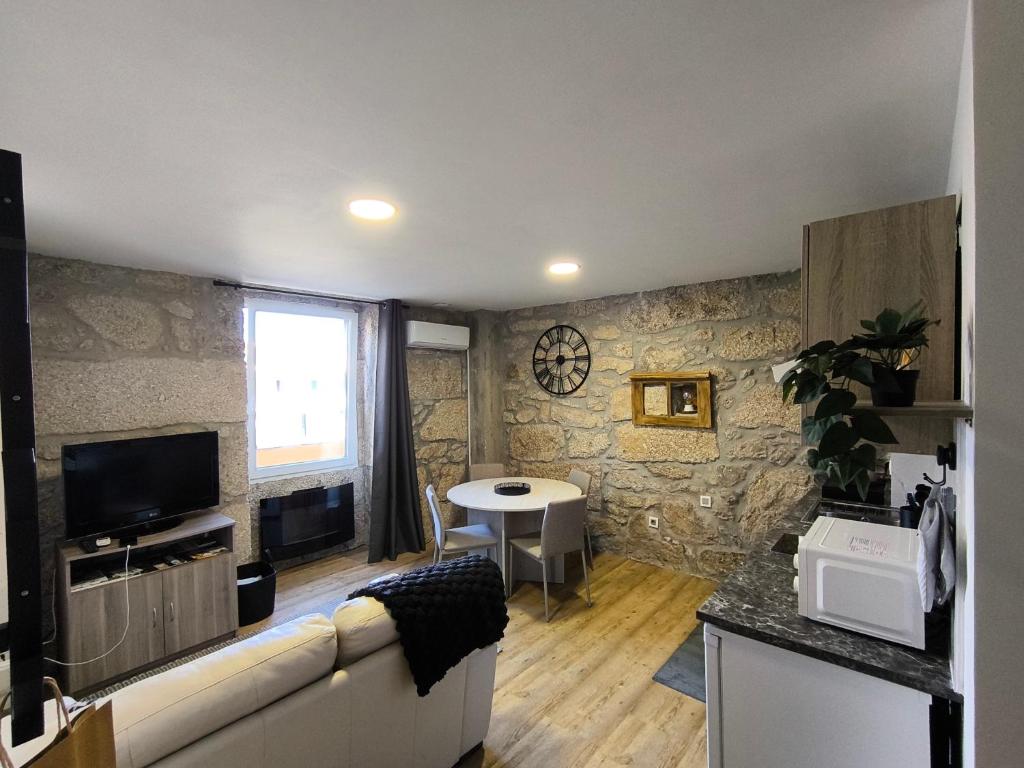 a living room with a couch and a table at Casa Stone in Guarda