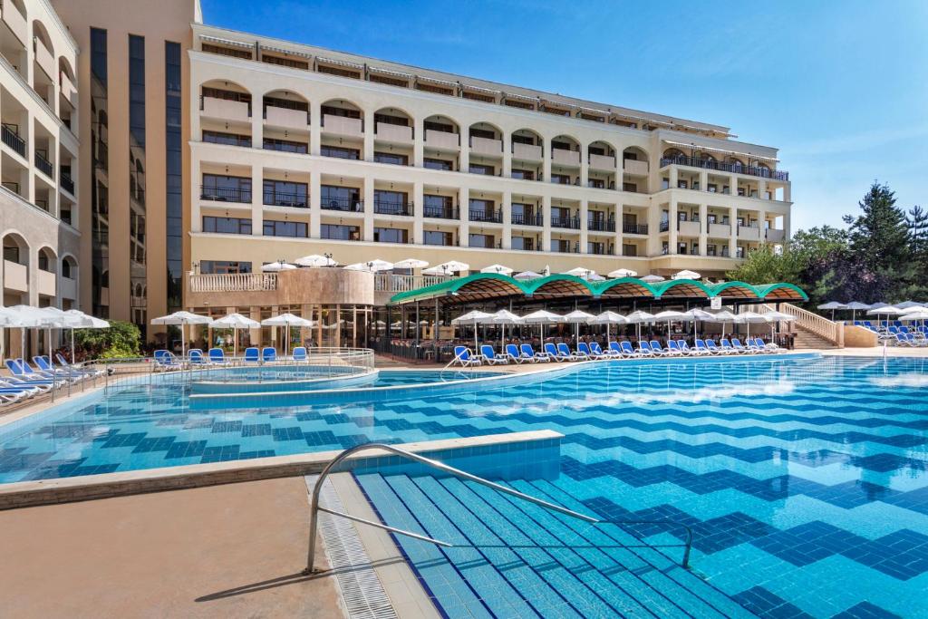 a large swimming pool with chairs and a hotel at SOL by Meliá Nessebar Bay All Inclusive in Nesebar