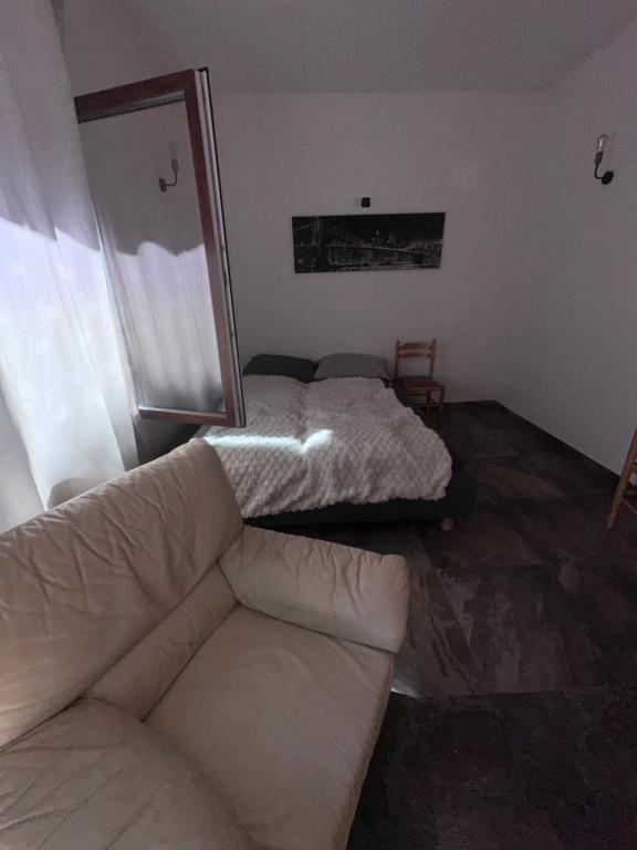 a living room with a couch and a mirror at Queens Safehouse in Brozany
