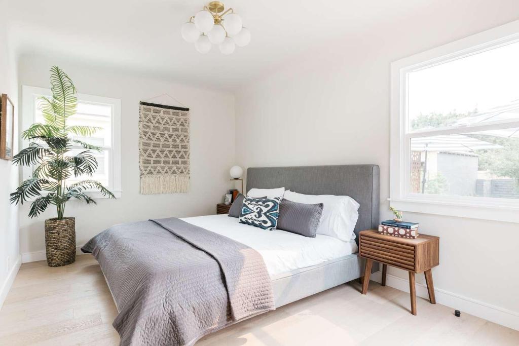a white bedroom with a large bed and a window at Guest HOuse BUlvard in Samarkand