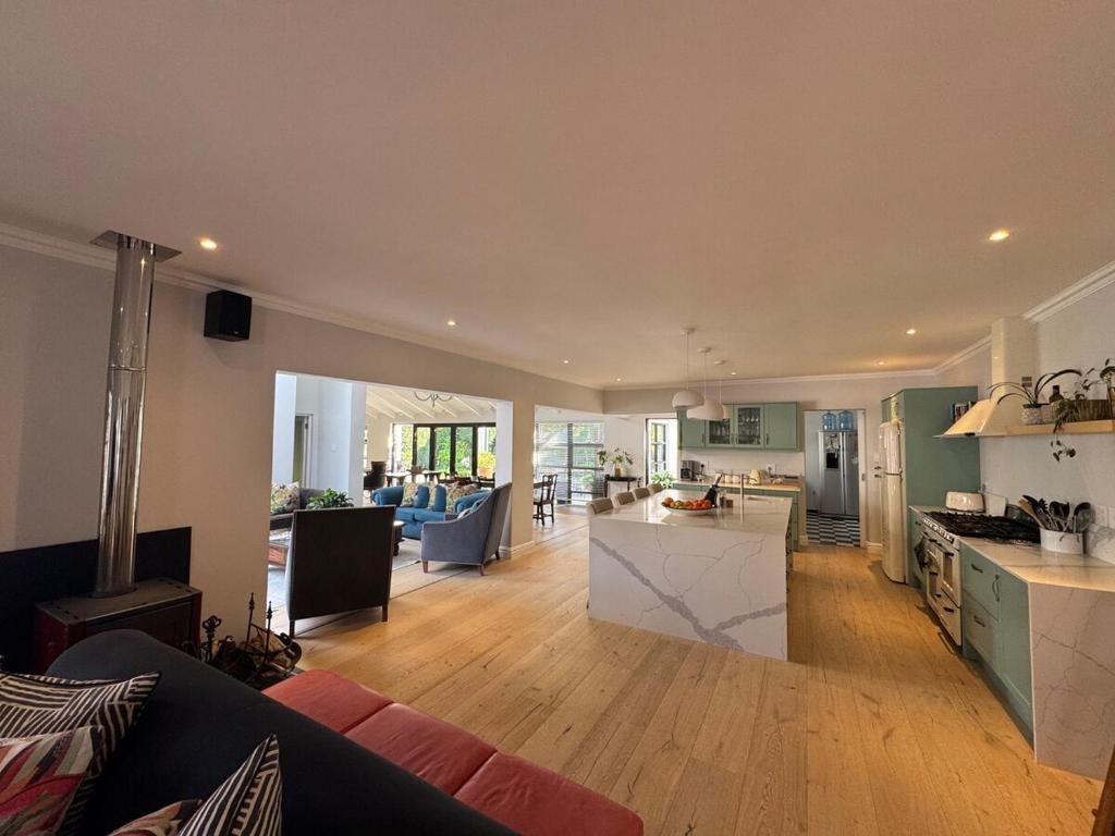 a kitchen and living room with a couch and a table at Upper Constantia Entertainers dream! in Cape Town