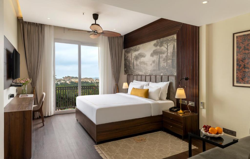 a bedroom with a bed and a large window at Oraka by My Downtown Aura Hotel in Udaipur