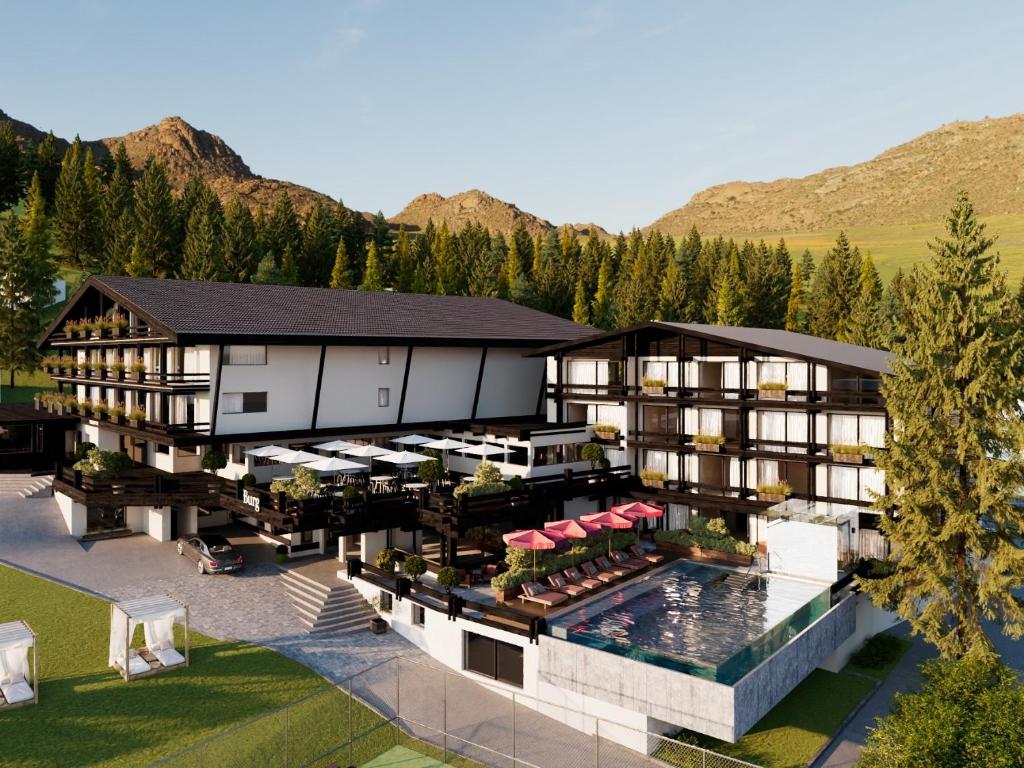 an aerial view of a resort with a swimming pool at Burg Hotel Lech am Arlberg in Lech am Arlberg