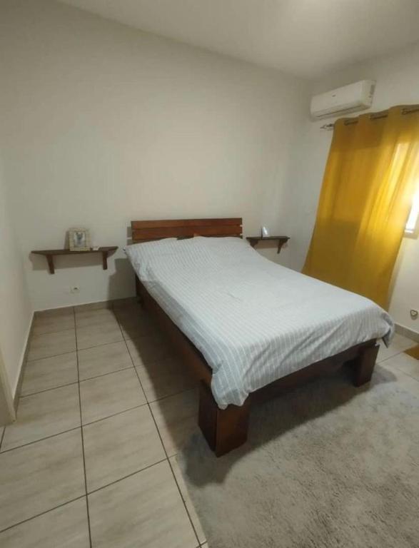 a bed in a bedroom with a white bedspread at La pace in Libreville
