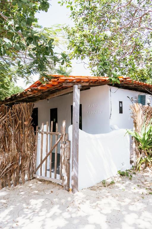 a house on the beach with a gate at Alto Saudade - Atins in Barreirinhas